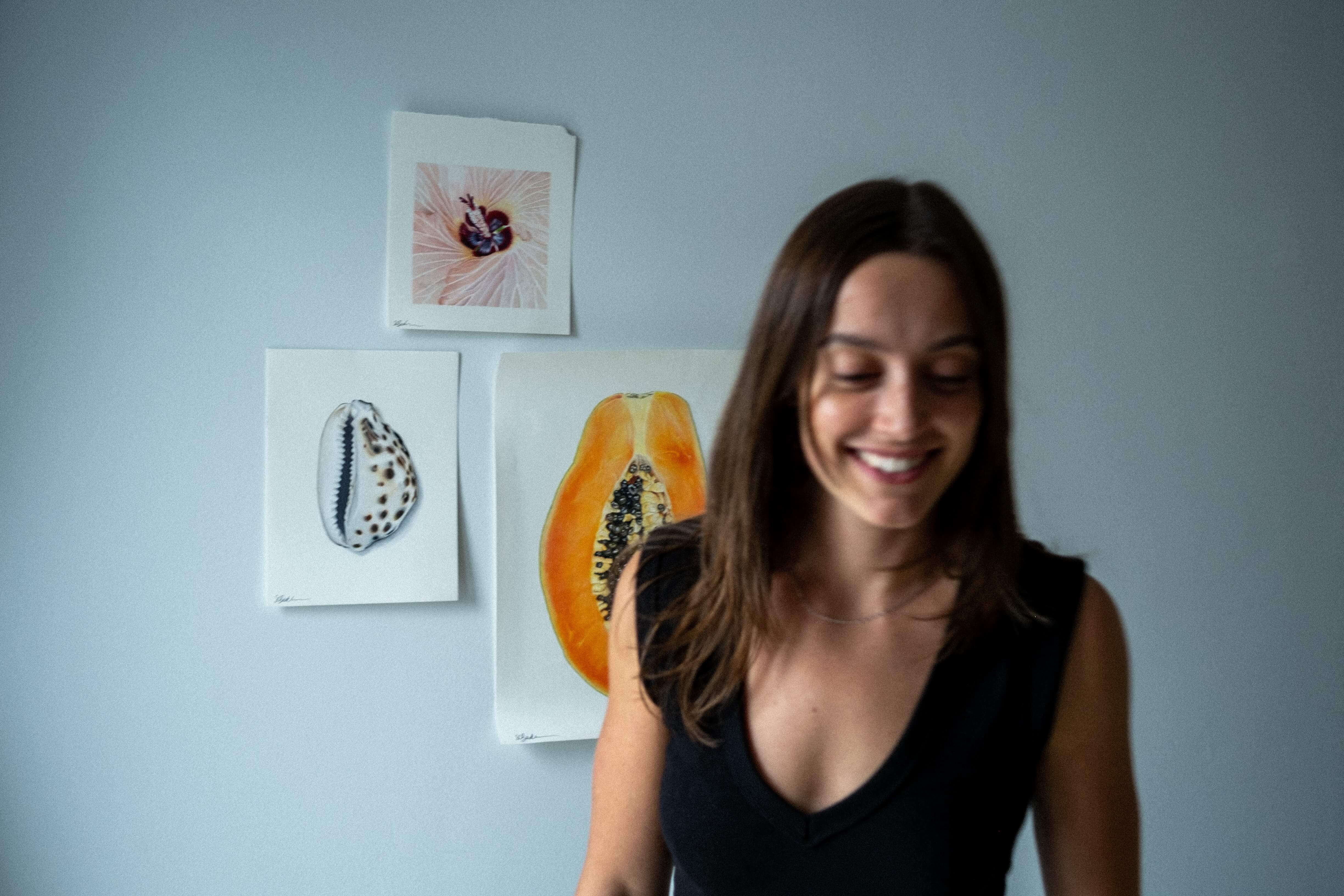 Artist smiling in front of artwork